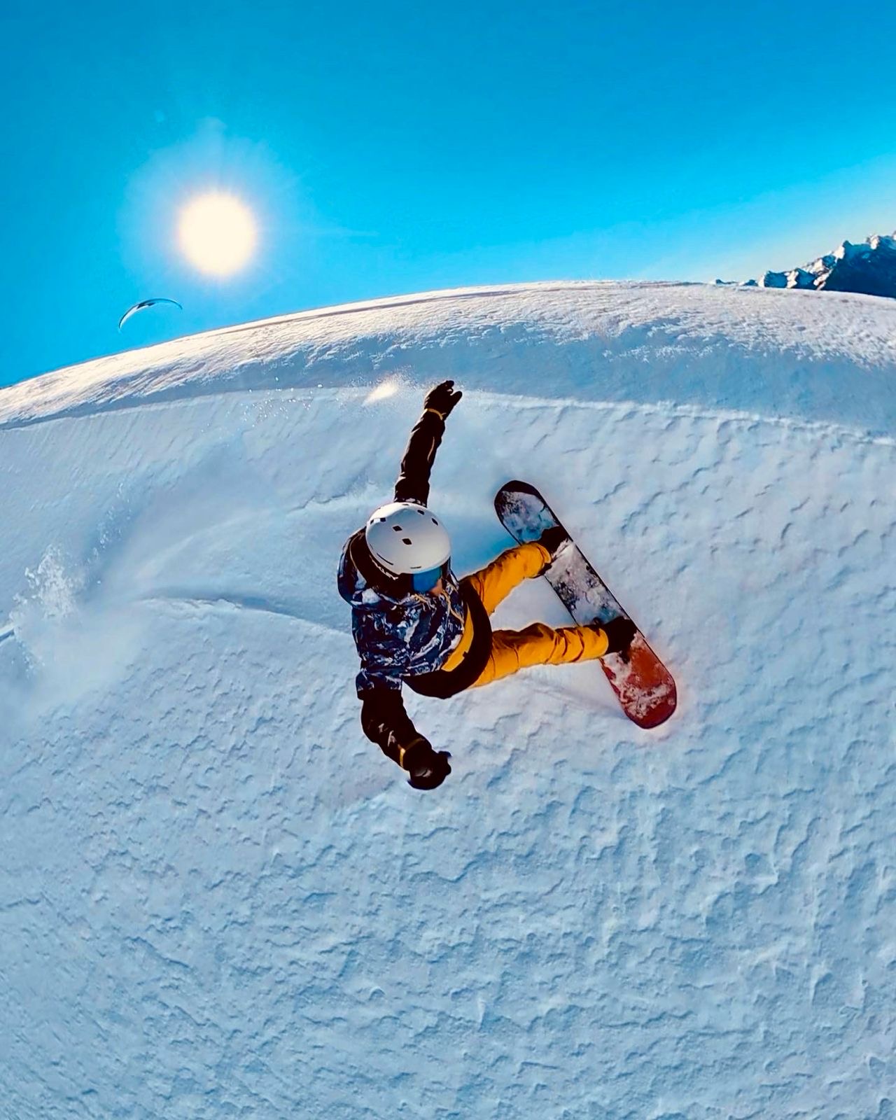 Snowboarder carving Swiss alpine relief